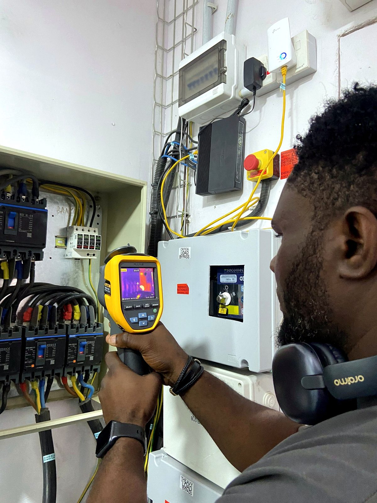 Engineer carrying out thermal imaging tests on an electrical panel