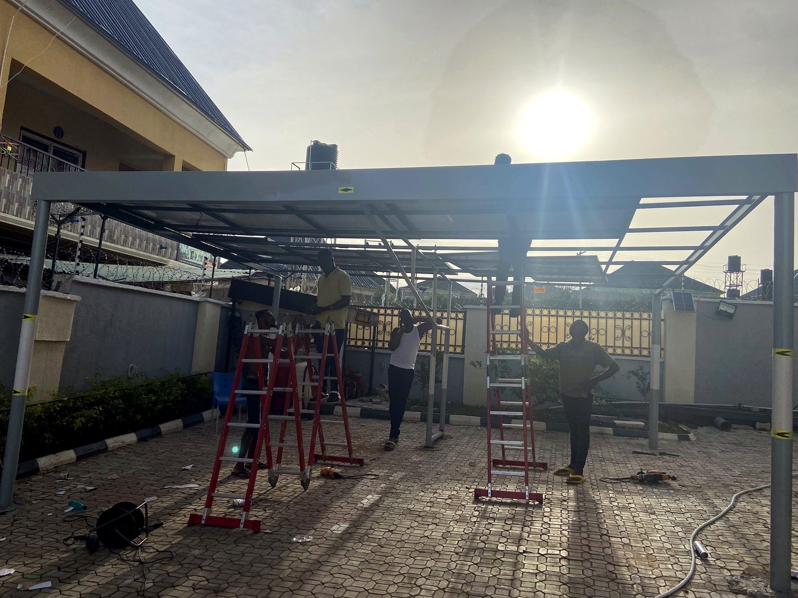 Engineers assembling a solar carport structure on site