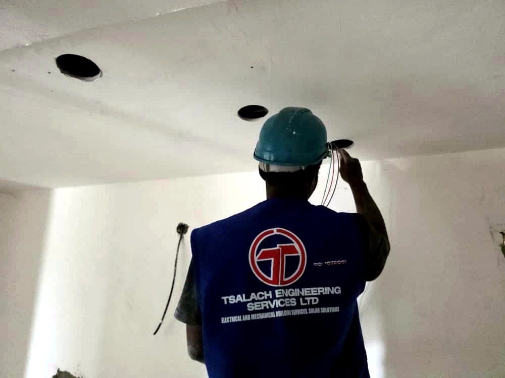 Tsalach technician installing ceiling cabling