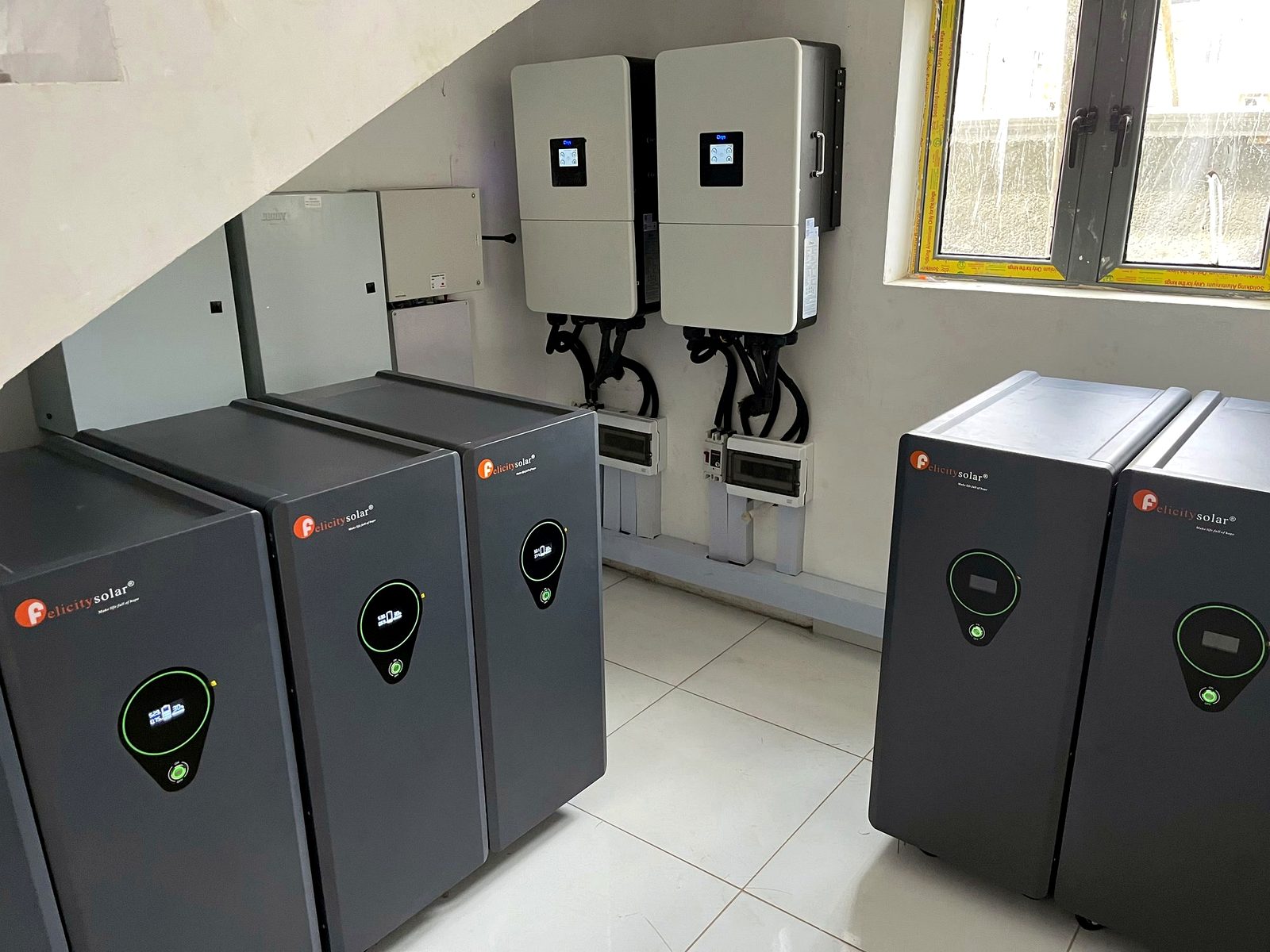 UPS cabinets and wall-mounted inverters in a power room